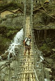 Harvey Mudd Watson Fellow Alan Baron on a suspension bridge in Nepal